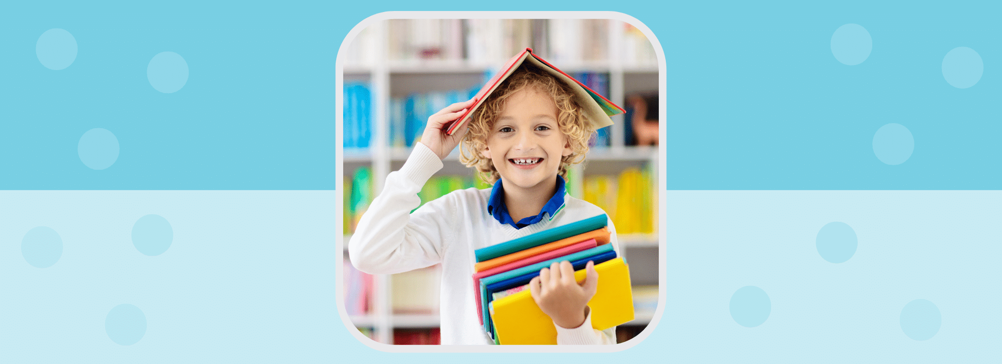 image showing a young boy holding some books in his hands and one book on his head